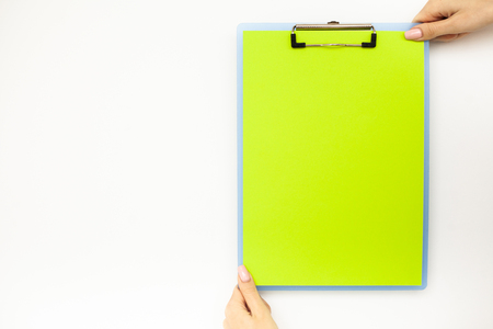 Blank Folder with Green Paper. Hand that Holding Folder and Handle on White Background. Copyspace. Place for Textの写真素材