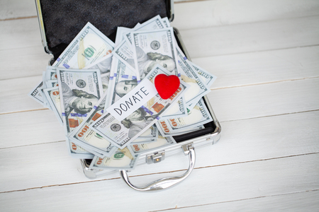 Donation Concept. Case with Dollars on White Background. Donations. High Resolutionの写真素材