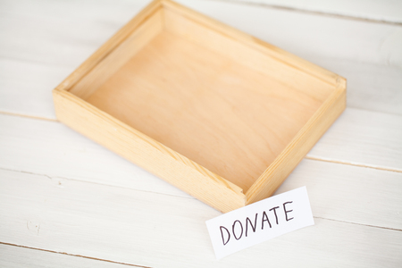 Donations and Charity. Donation Concept. A Donation Box on the White Background. Inscription Donateの写真素材