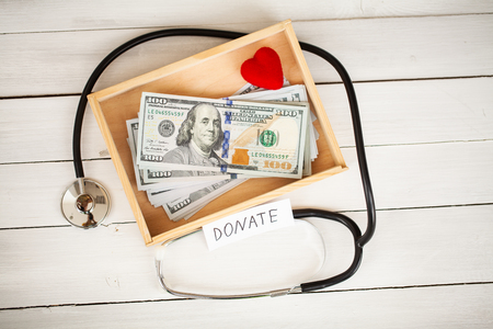 Donation Concept. Box with Dollars on White Background. Donations. High Resolutionの写真素材