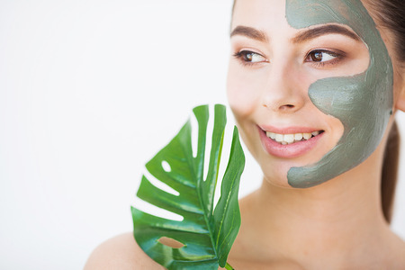 Skincare. Beautiful Woman With Perfect Skin Near Green Leaf Over White Backgroundの写真素材
