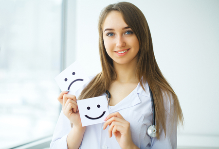 Doctor holding a card with symbol Smile, Medical conceptの写真素材
