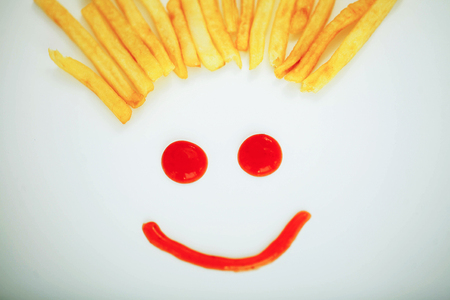 Diet. Funny Face. Golden Frost Potato on White Background. Dieto