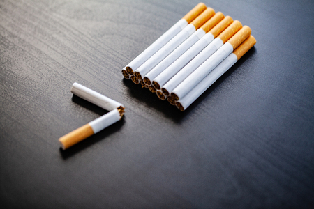 Stop smoking concept on background with broken cigarettes. Heap of cigarettes. No smokingの写真素材