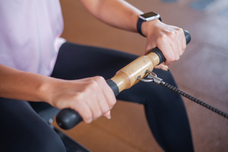 Young woman exercising with weight in the gym