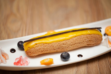 Tasty piece of chocolate cake on wooden table backgroundの写真素材