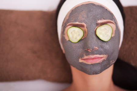 young beautiful woman with facial mask, spa treatmentの写真素材