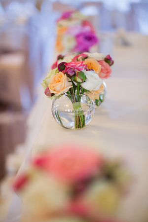 Wedding decoration on table. Floral arrangements and decoration. Arrangement of pink and white flowers in restaurant for luxury wedding eventの写真素材
