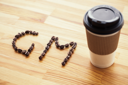 Good Morning. Coffee Time. Coffee to go and beans on a wooden backgroundの写真素材