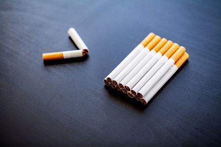 Stop smoking concept on background with broken cigarettes. Heap of cigarettes. No smokingの写真素材