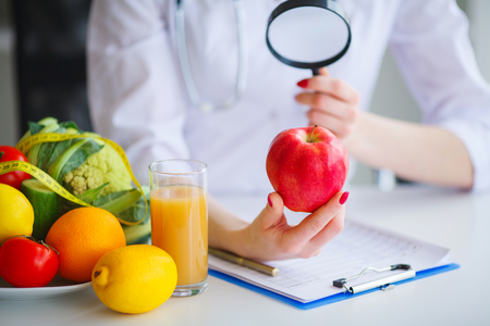 Some Fruits Such As Apples, Kiwis, Lemons And Berries On Nutritionist Tableの写真素材