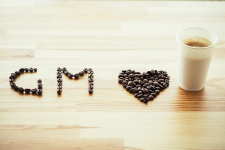 Good Morning. Coffee Time. Coffee to go and beans on a wooden backgroundの写真素材