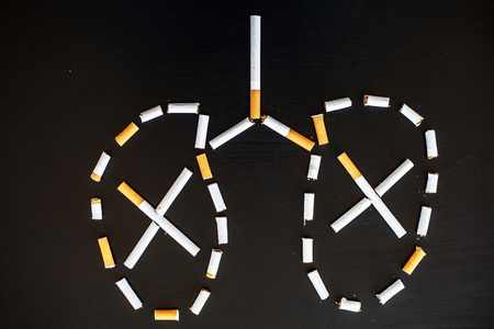 Stop smoking concept on background with broken cigarettes. Heap of cigarettes. No smokingの写真素材