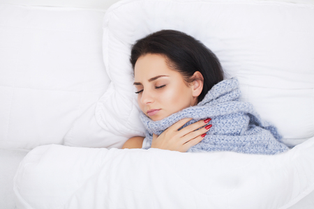 Cold And Flu. Portrait Of Ill Woman Caught Cold, Feeling Sick And Sneezing In Paper Wipe. Closeup Of Beautiful Unhealthy Girl Covered In Blanket Wiping Nose. Healthcare Concept. High Resolutionの写真素材