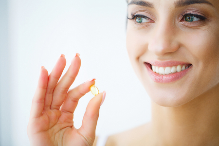Nutrition. Healthy Lifestyle. Woman Holding Pill With Fish Oil Omega-3. Supplements, Vitamins.の写真素材