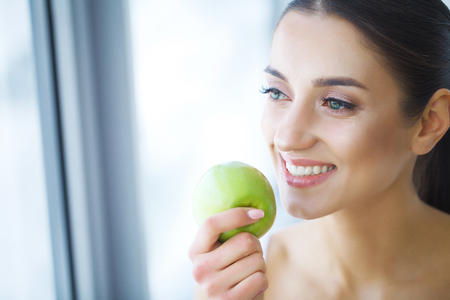 Woman With Apple. Beautiful Girl With White Smile, Healthy Teeth. High Resolution Imageの写真素材