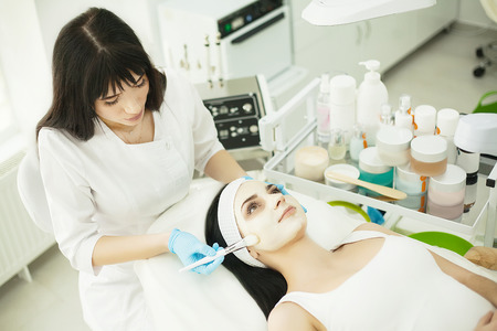 Woman with facial mask in beauty salonの写真素材