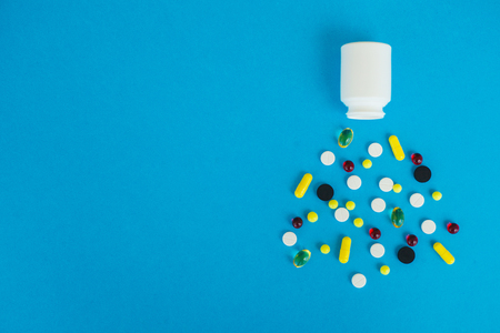 Medical Pills. Colored Pills And Capsule On Blue Background. Pharmacy Theme, Capsule Pills With Medicine Antibiotic in Packagesの写真素材