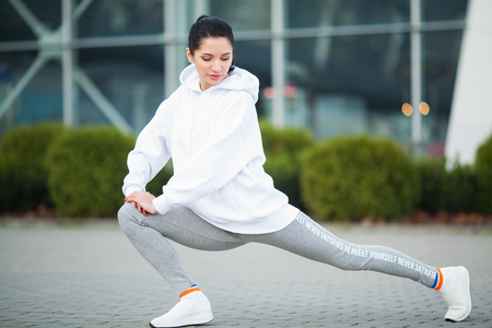 Fitness. Beautiful young woman exercising in the park - Sport and healthy lifestyle conceptの写真素材
