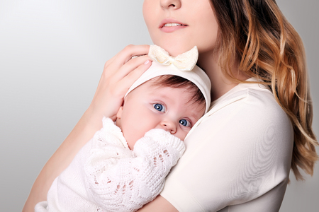 happy caring mother and her cute baby girlの写真素材