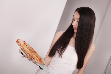 Diet And Fast Food Concept. Woman Holding Pizza. Unhealthy Junk Food. Dieting, Lifestyle. Weight Loss. Obesity. Top Viewの写真素材