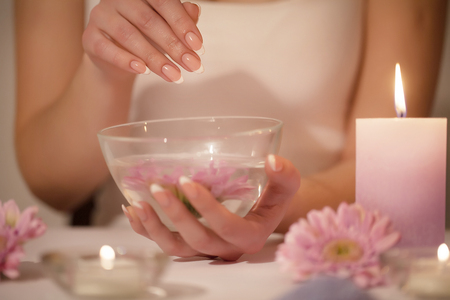 Woman hands in a nail salon receiving a hand scrub peeling by a beautician. SPA manicure, hand massage and body care, spa treatments.の写真素材