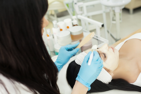 Girl At Spa Salon. Beautician Applying White Cosmetic Powderの写真素材