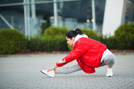 Woman Stretching Body, Doing Exercises On Streetの写真素材
