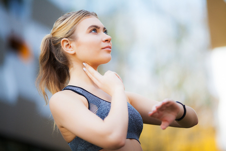 Female runner stretching before running in city parkの写真素材