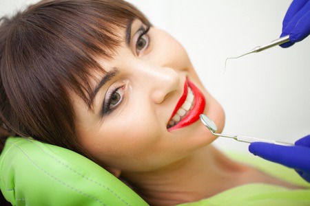 Young female patient visiting dentist office. Woman having teeth examined at dentistsの写真素材