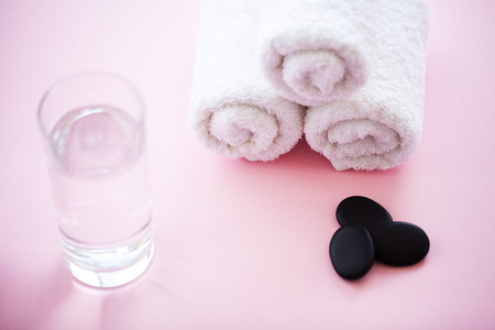 Spa. White Cotton Towels Use In Spa Bathroom on Pink Background. Towel Concept. Photo For Hotels and Massage Parlors. Purity and Softness. Towel Textileの写真素材