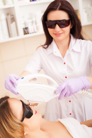 Skin care. Adult woman having laser hair removal in professional beauty salonの写真素材
