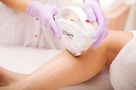 Skin care. Woman at cosmetics salon, legs laser epilation.の写真素材