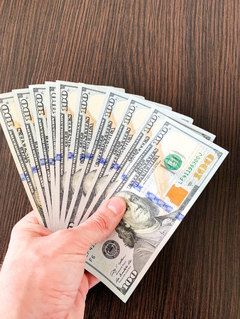 Finance money. Closeup of hand holding dollars