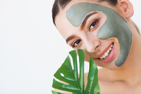 Face Mask. Beautiful Smiling Woman Applying Mask On Faceの写真素材
