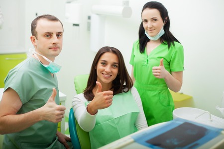 Patient in dentistry. Pretty woman visiting her dentist in clinicの写真素材