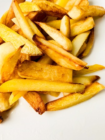 Teasty food. Fried potato on white plateの写真素材