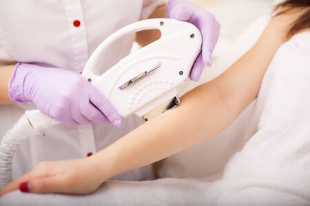 Skin care. Hands Laser epilation and cosmetology. Hair removal cosmetology procedureの写真素材