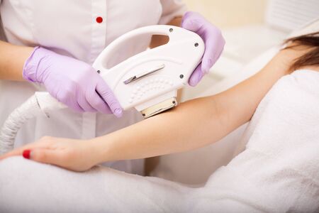Skin care. Hands Laser epilation and cosmetology. Hair removal cosmetology procedureの写真素材