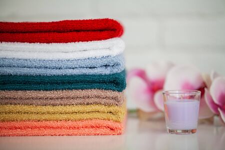 Towels and a branch of an orchid on a white background. Aromatherapy. Spa and Hygieneの写真素材