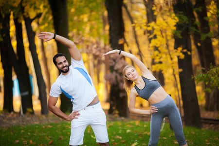 Fitness. Personal Trainer Takes Notes While Woman Exercising Outdoor