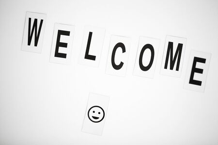 Welcome word written on white table. Copy spaceの写真素材