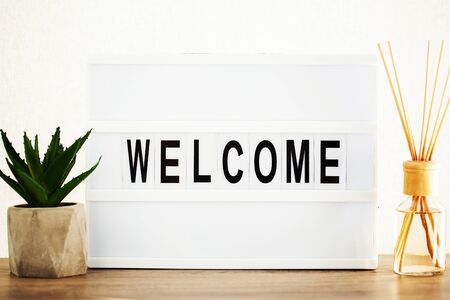 Led letter board with welcome word on table.の写真素材
