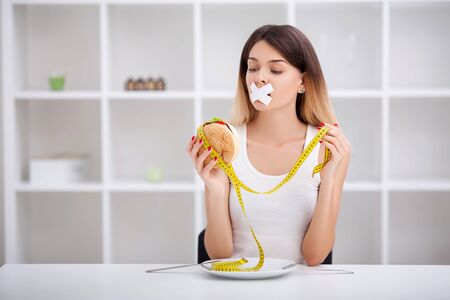 Unhealthy eating. Junk food concept. Girl dont eat junk foodの写真素材