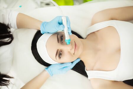 Body Care. Woman Receiving Face Skin Analysis. Cosmetologyの写真素材