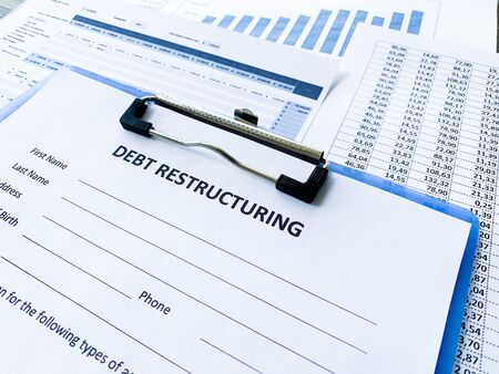 Debt restructuring document with graph on table.の写真素材