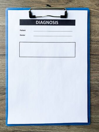 Diagnosis form with the patients data on the doctors desk.の写真素材