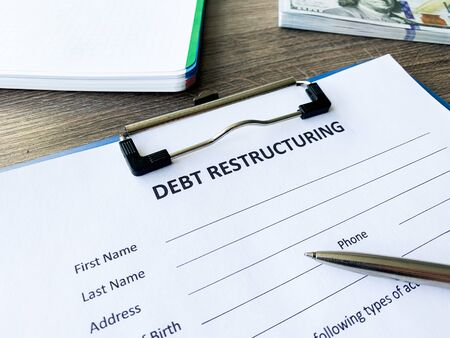 Debt restructuring document with graph on table.の写真素材