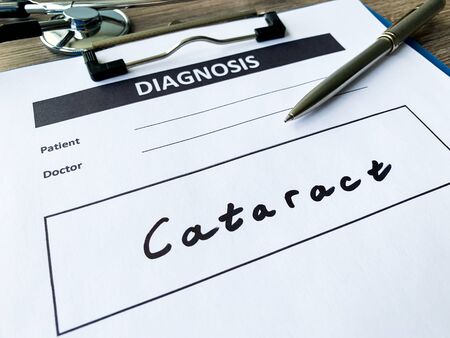 Diagnosis cataract in a medical form on the doctor desk