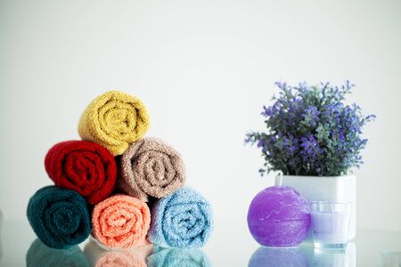Colored towels on white table with copy space on bath room backgroundの写真素材